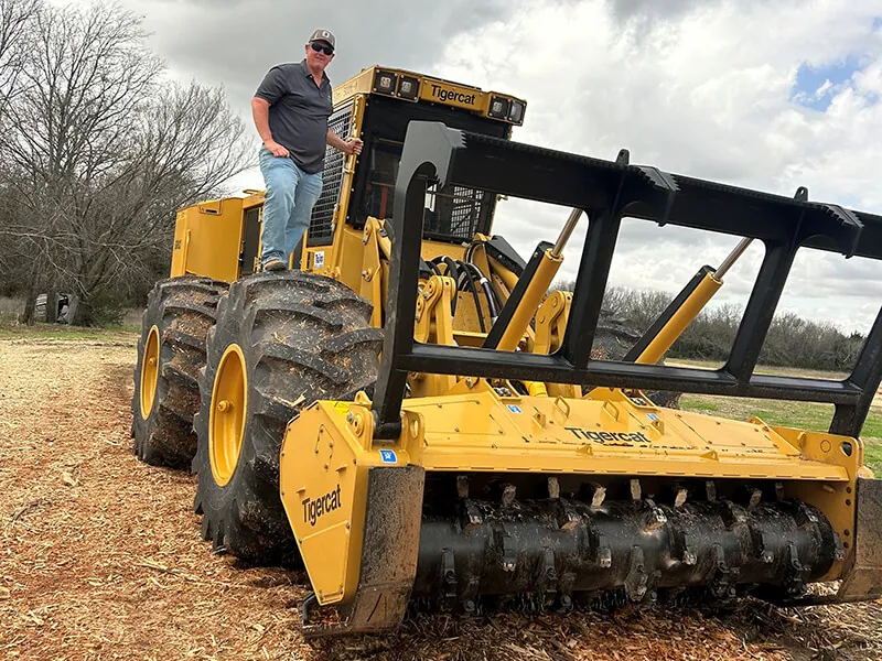 Operator on a Tigercat land clearing machine